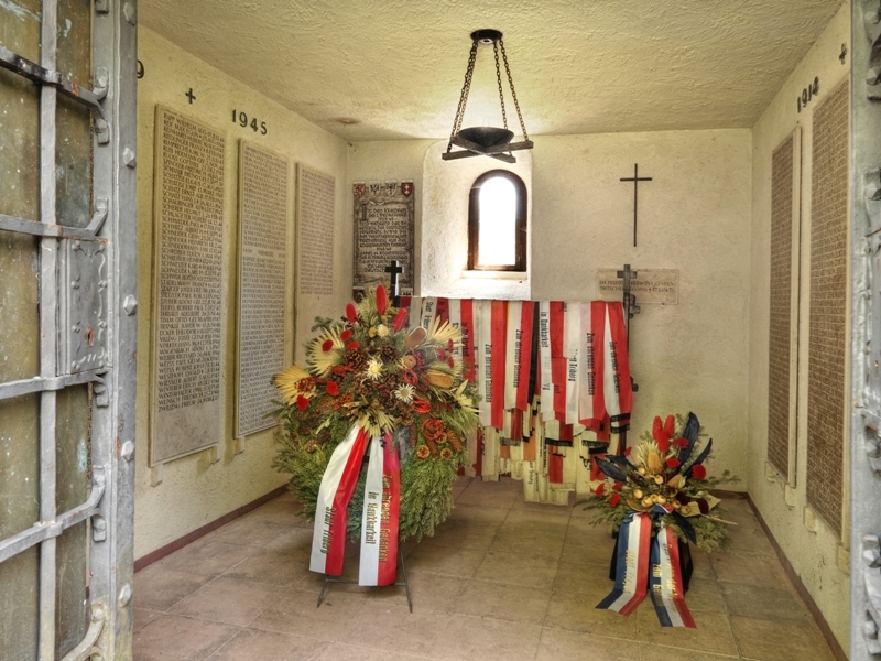 Crypt-like memorial room with marble plaques
